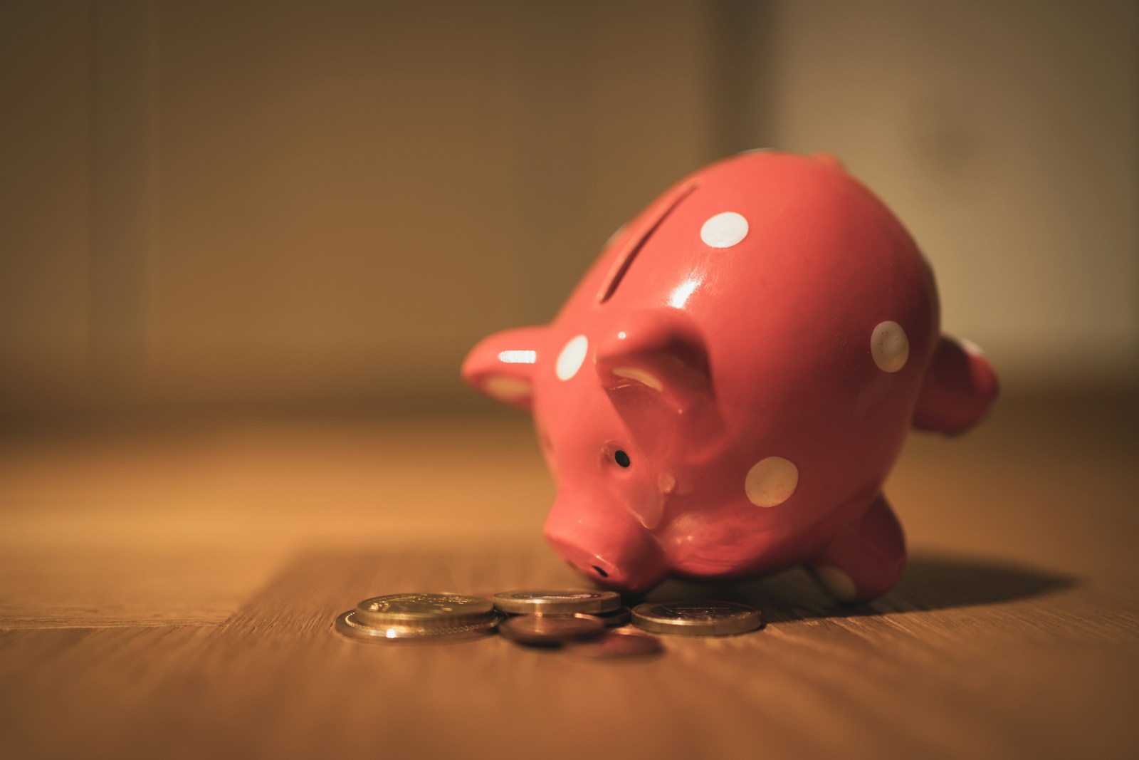 pink pig coin bank on brown wooden table symbolizing how to rightsize your insurance budget